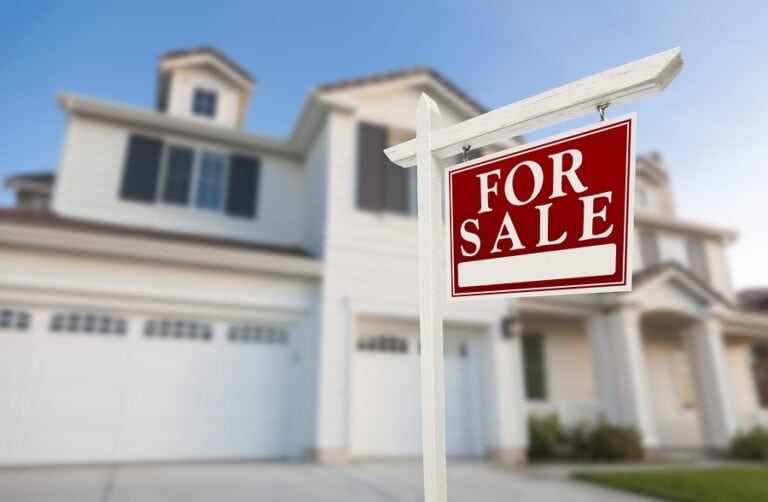for sale sign in front of house