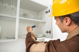 handyman inspecting cabinets