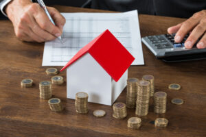 Cropped,Image,Of,Businessman,Calculating,Tax,By,Model,House,And, Inflation housing market