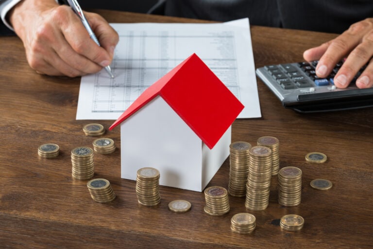 Cropped,Image,Of,Businessman,Calculating,Tax,By,Model,House,And, Inflation housing market
